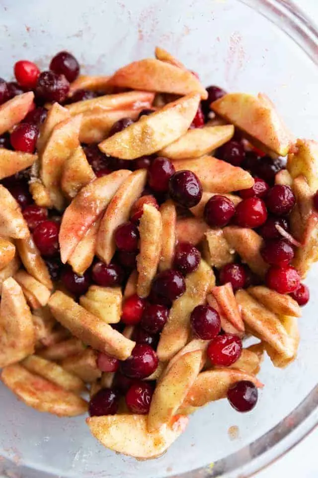 overhead view of apple cranberry pie filling in a glass bowl