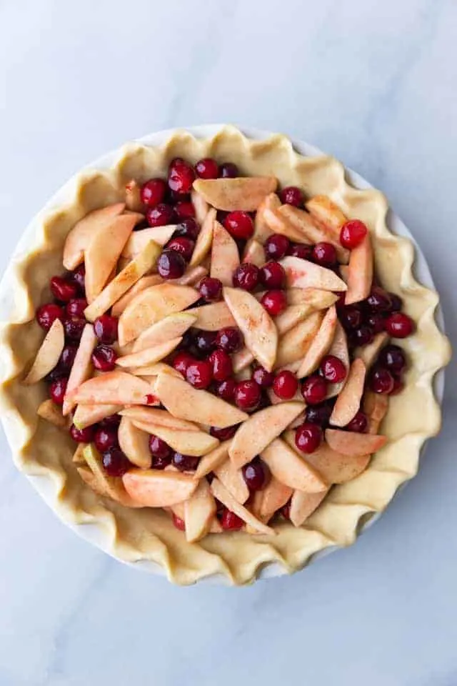 overhead view of apple cranberry filling in an unbaked pie shell