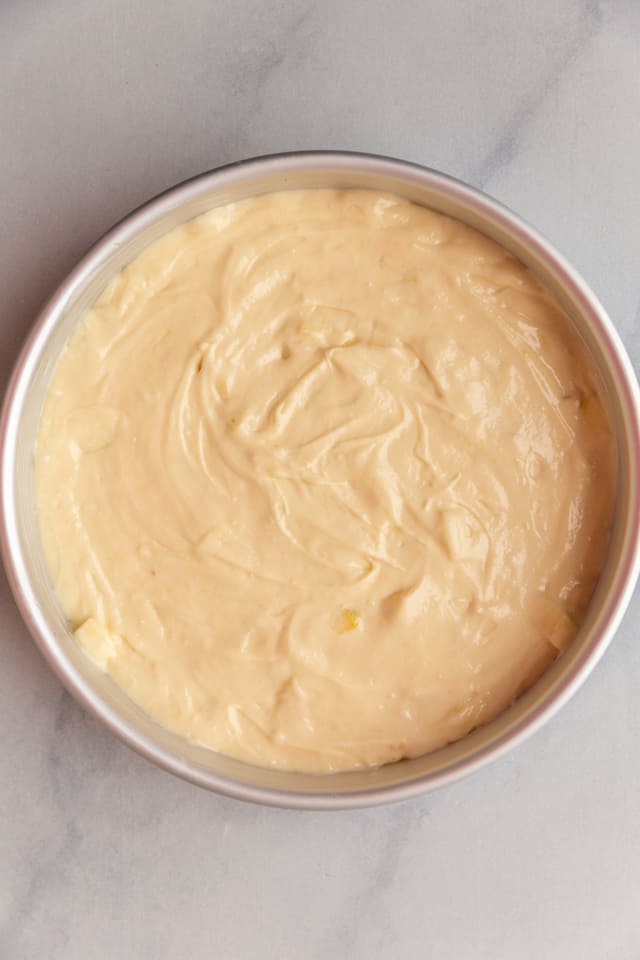 overhead view of apple cake batter in a pan