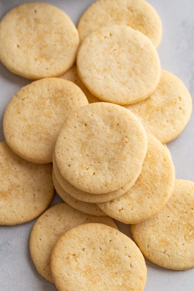 overhead view of basic butter cookies scattered on white parchment paper