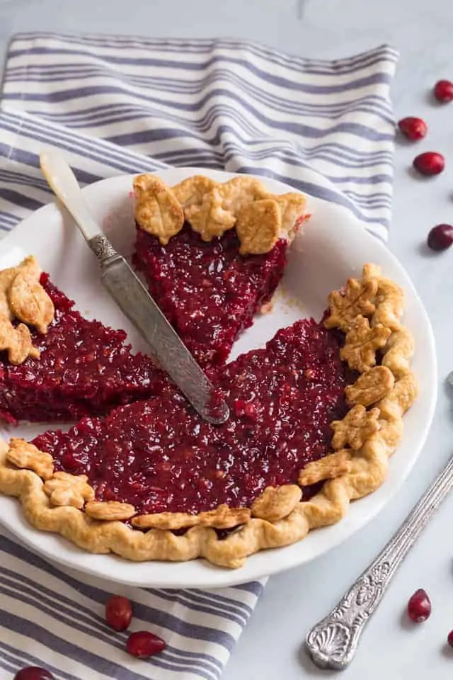 high angled view of a cranberry pie with slices taken out