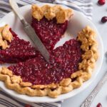high angled view of a cranberry pie with slices taken out