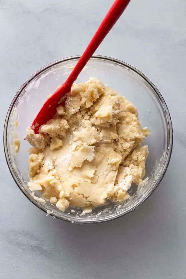 overhead view of crust dough in a glass bowl