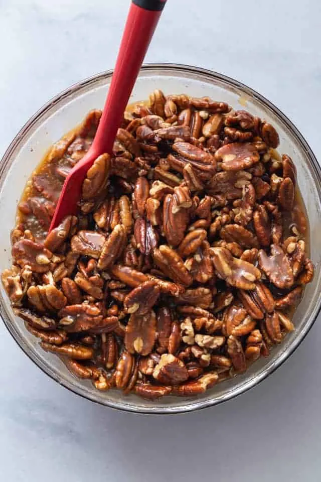 overhead pecan pie bars topping in a glass bowl