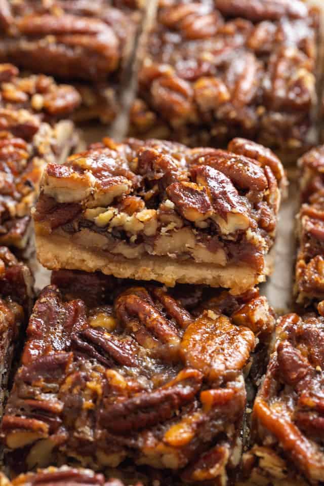 close up of the side of a pecan pie bar so the filling is visible