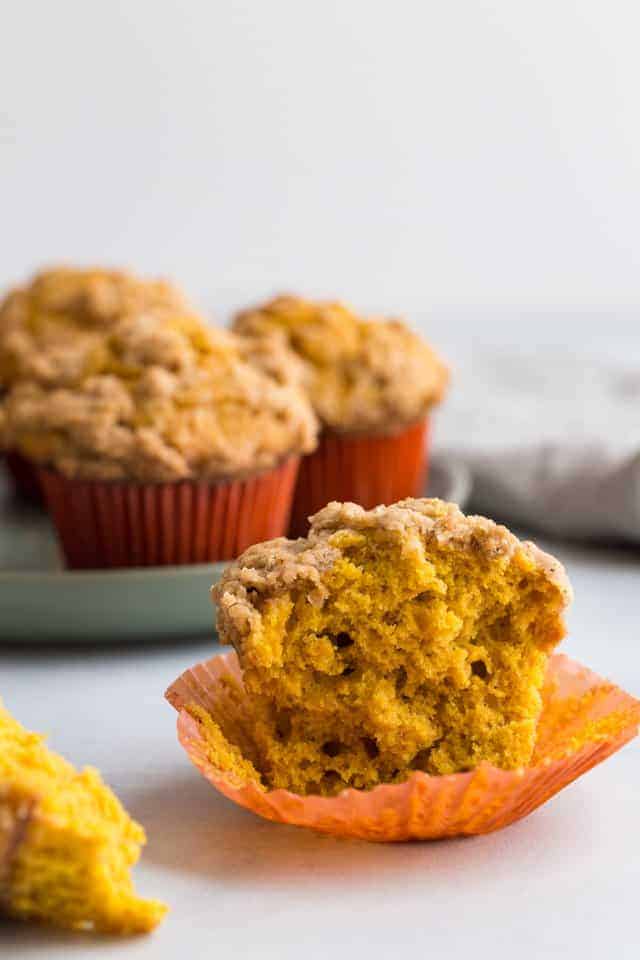 side view of half a pumpkin muffin with the fluffy center exposed