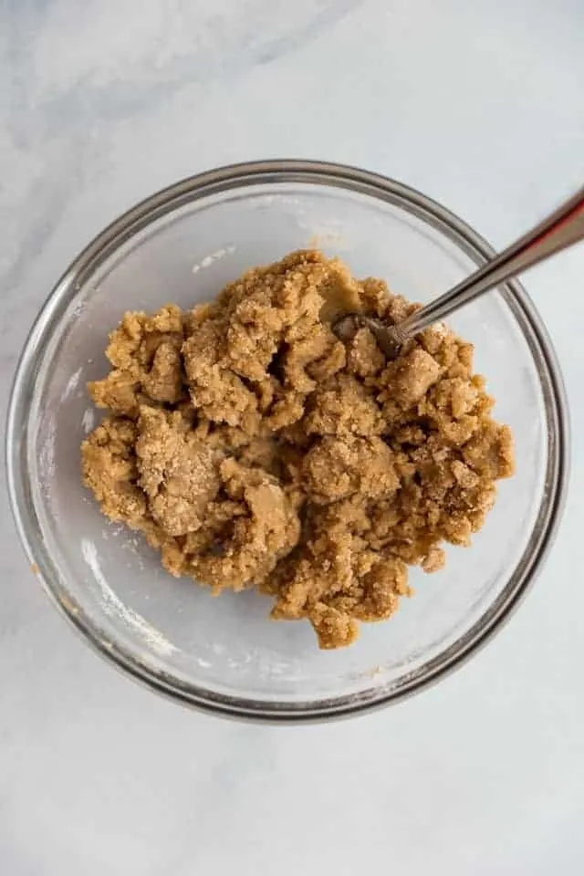 overhead view of streusel topping in a glass bowl