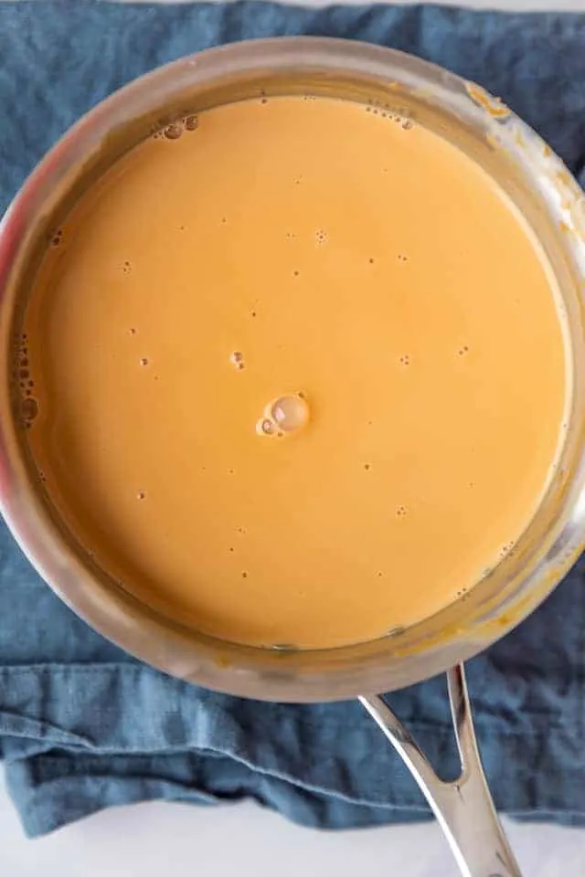 overhead view of milk syrup for tres leches cake in a pot