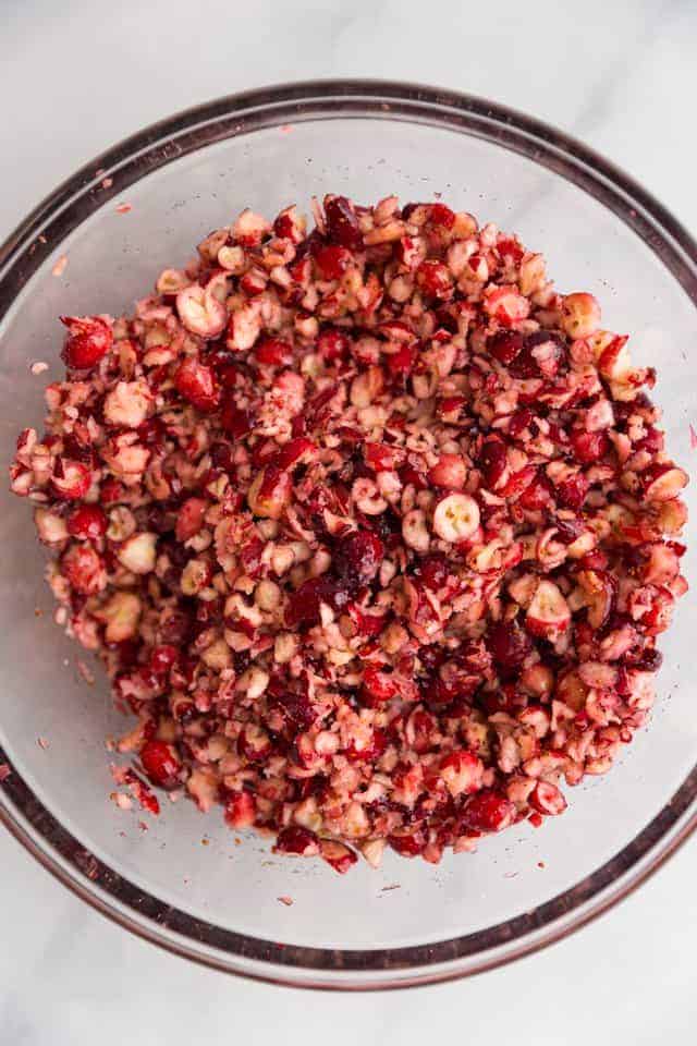 overhead view of chopped cranberries in a glass bowl