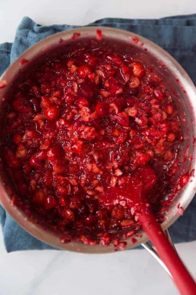 overhead view of cranberry pie filling in a stainless steel pot