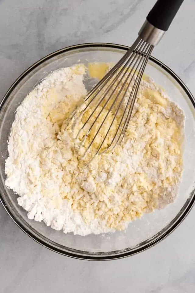 flour mixed with egg yolks in a glass bowl