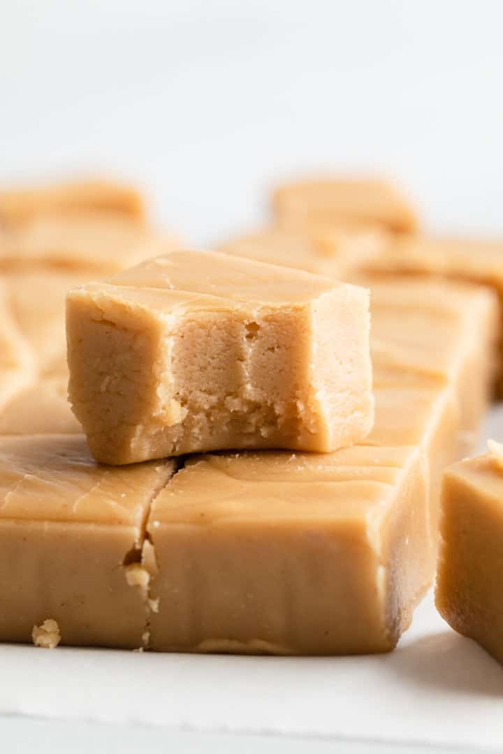a stack of peanut butter fudge with a bite taken out of one piece
