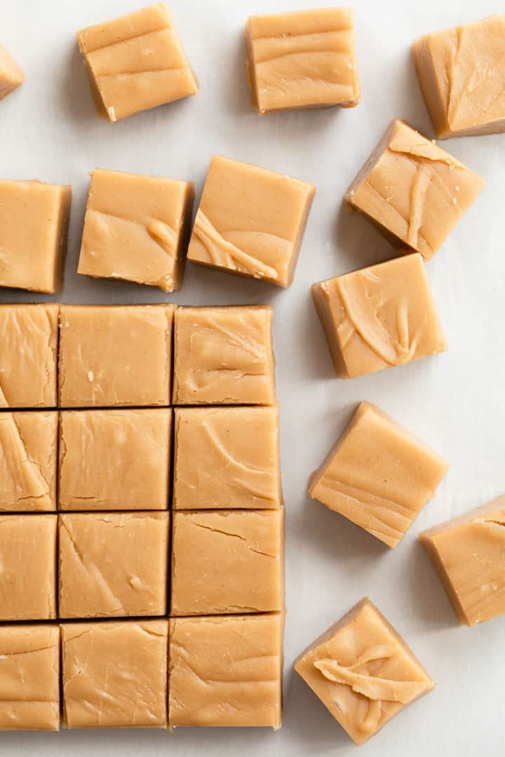 overhead of sliced peanut butter fudge on a white cutting board