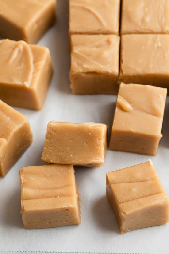 peanut butter fudge scattered on white parchment paper