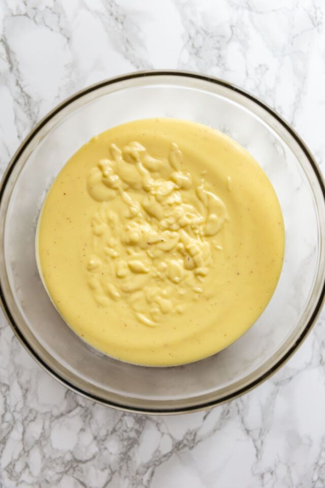 Overhead view of fluffy custard for banana cream pie in a glass bowl.
