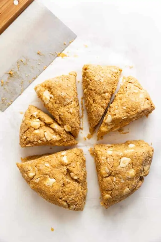 pumpkin scone dough being cut into triangles
