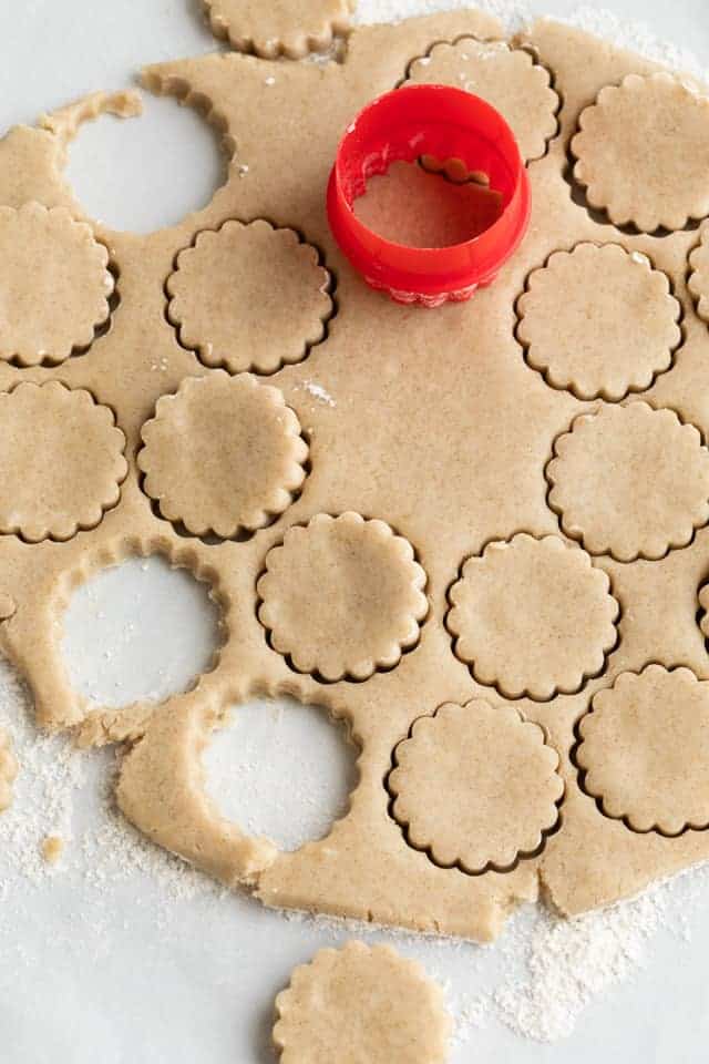 cardamom cookies cut out with red round cookie cutter