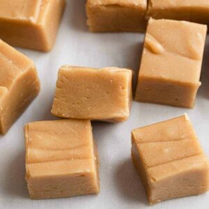 peanut butter fudge scattered on white parchment paper