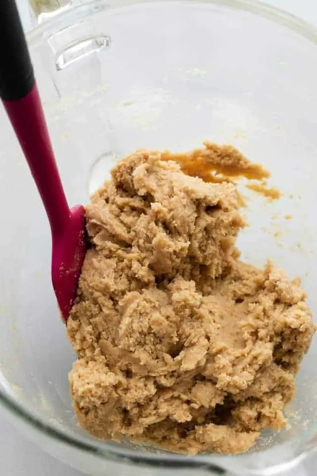 cookie dough in glass bowl with spatula