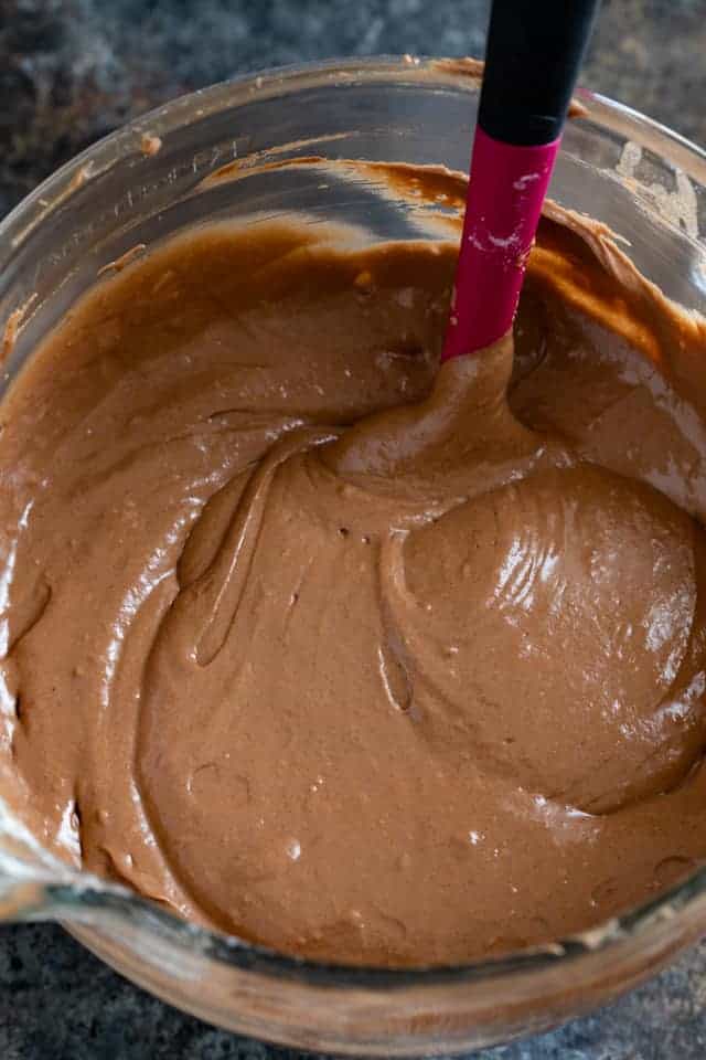 Chocolate cake batter in a glass mixing bowl