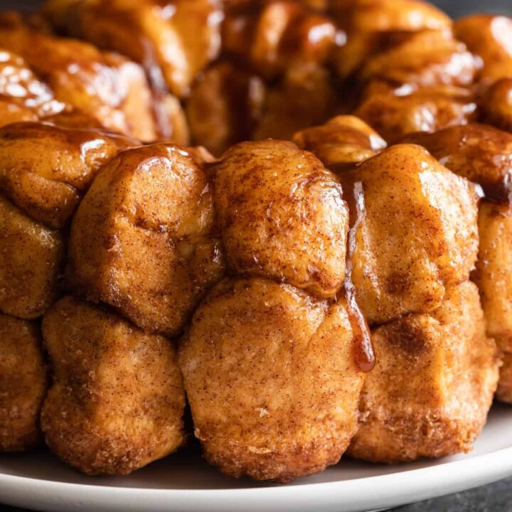 close up of gooey monkey bread on white plate