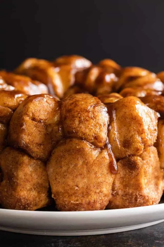 close up of gooey monkey bread on white plate