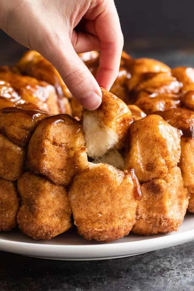 hand pulling off a piece of monkey bread