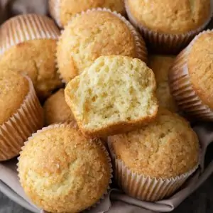 basic muffins with one broken open so the inside is visible