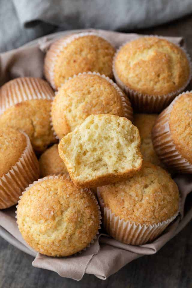 basic muffins with one broken open so the inside is visible