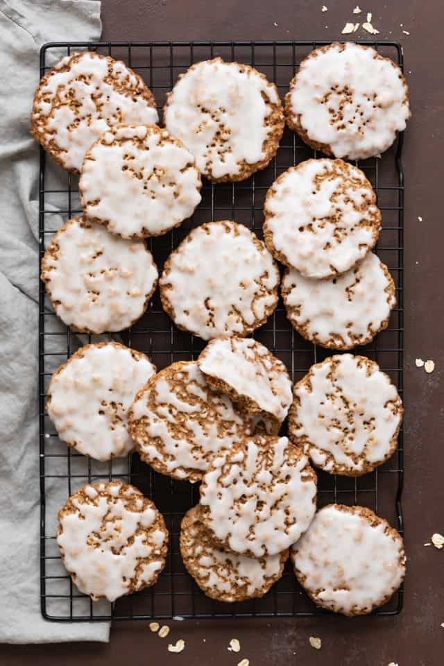 overhead of oatmeal cookies topped with icing on wire rack