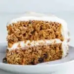 side view of carrot cake slice on white plate