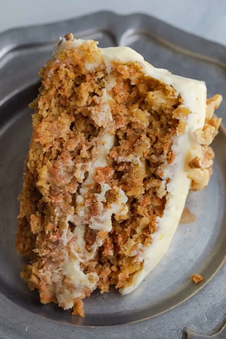 slice of carrot cake with pineapple on a pewter plate