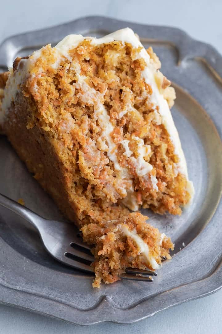 carrot cake with pineapple on a pewter plate with fork