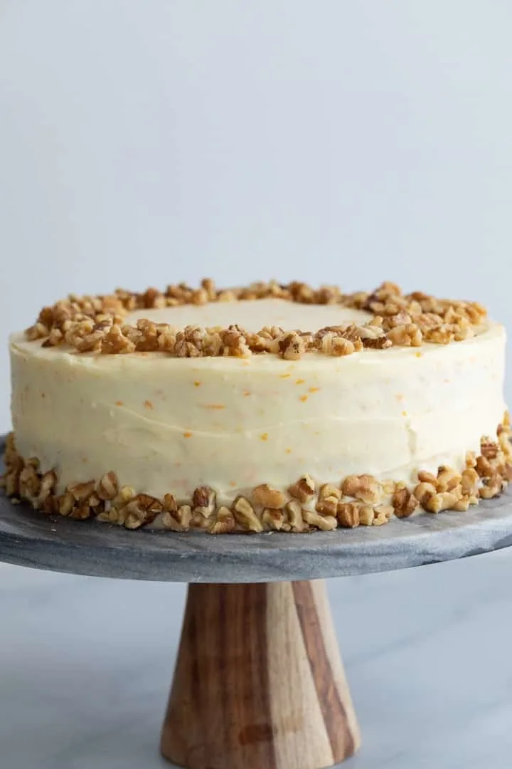 ultimate pineapple carrot cake on a grey marble cake stand