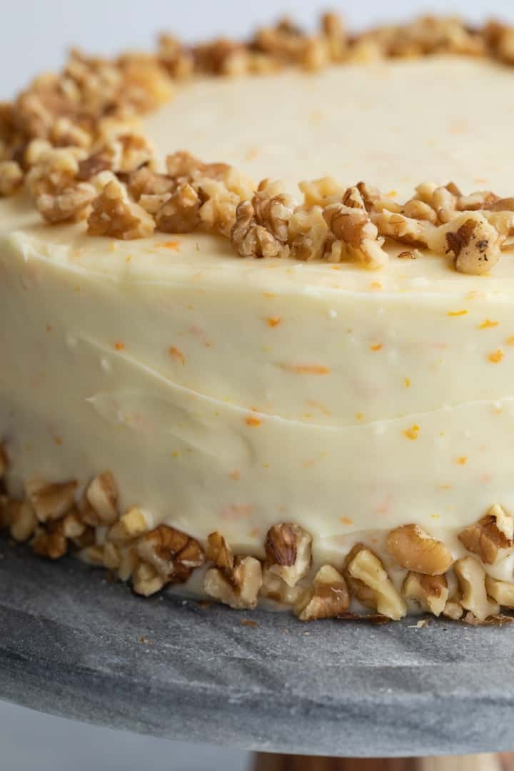 close up of pineapple carrot cake with orange cream cheese frosting