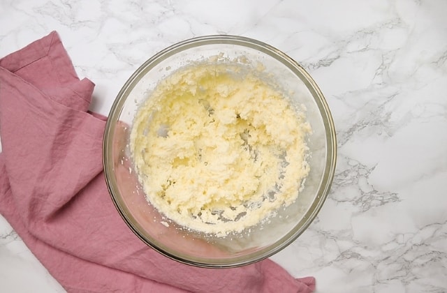 creamed butter and sugar in glass bowl