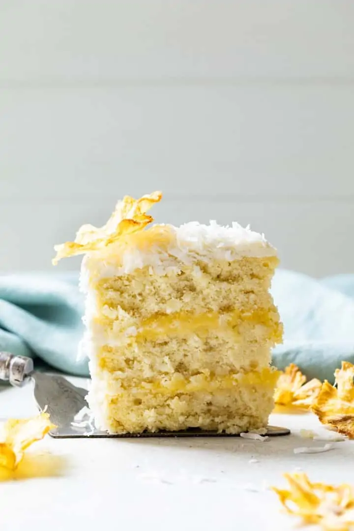 slice of pineapple coconut cake on a serving spatula