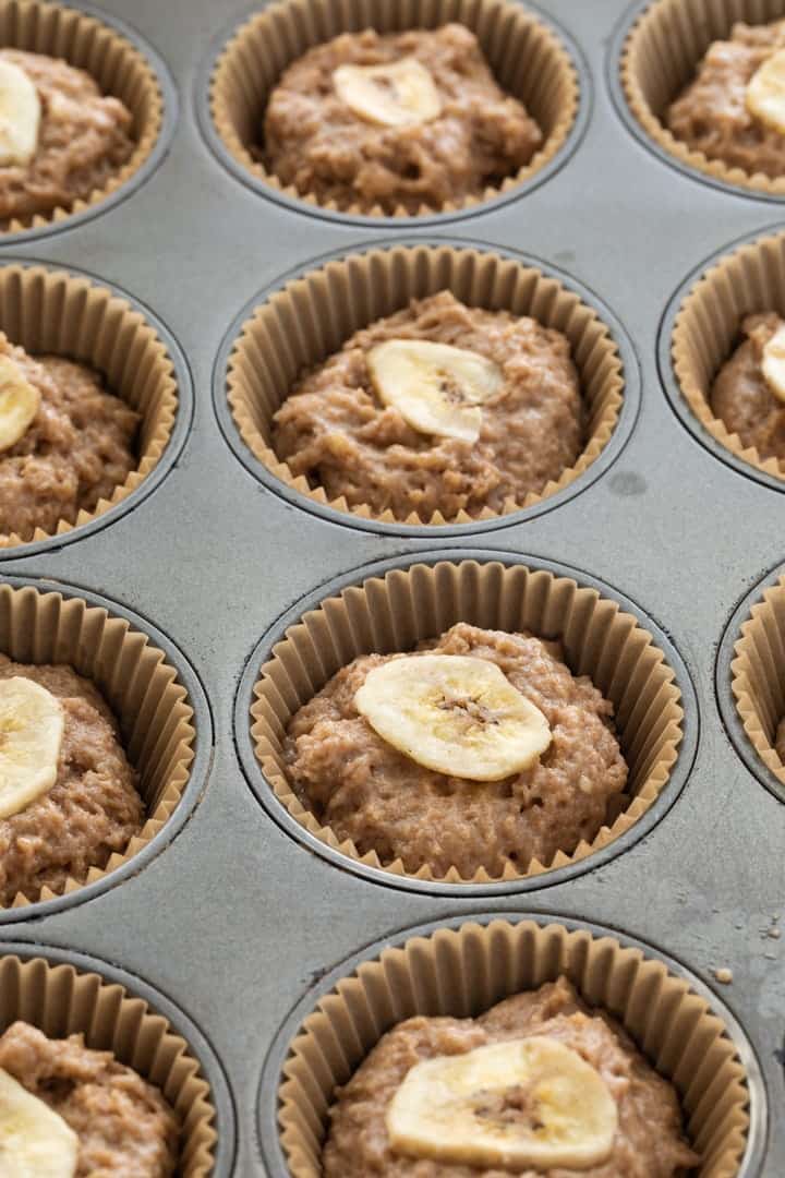 whole wheat banana muffin batter in paper-lined muffin pan