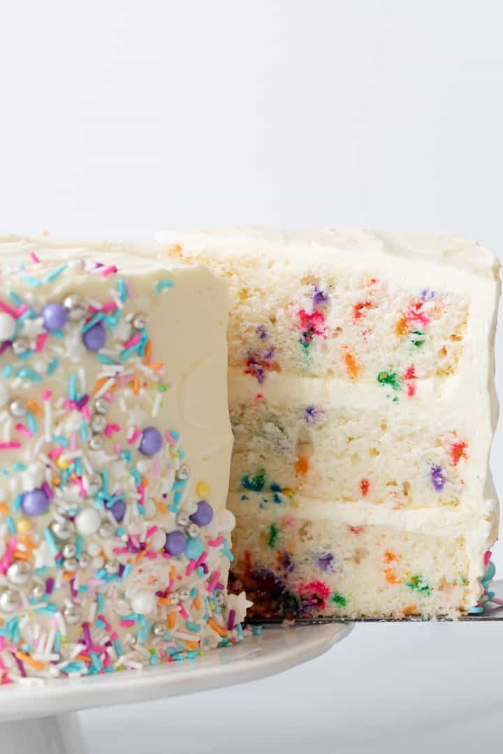 side view of slice of funfetti cake being taken out