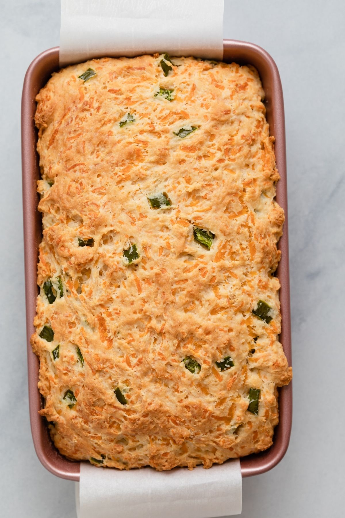 baked cheddar jalapeno buttermilk bread in a loaf pan