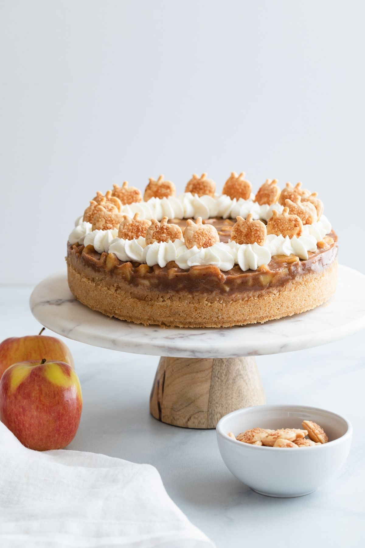 apple pie cheesecake on a marble cake stand