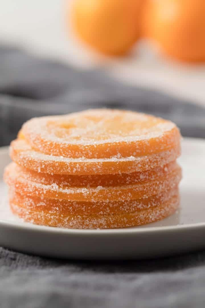 A stack of candied orange slices on a white plate