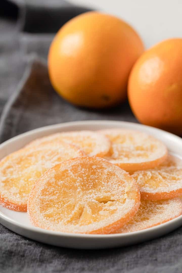 side view of candied orange slices arranged on a plate