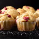 close up of cranberry orange muffins on a cooking rack