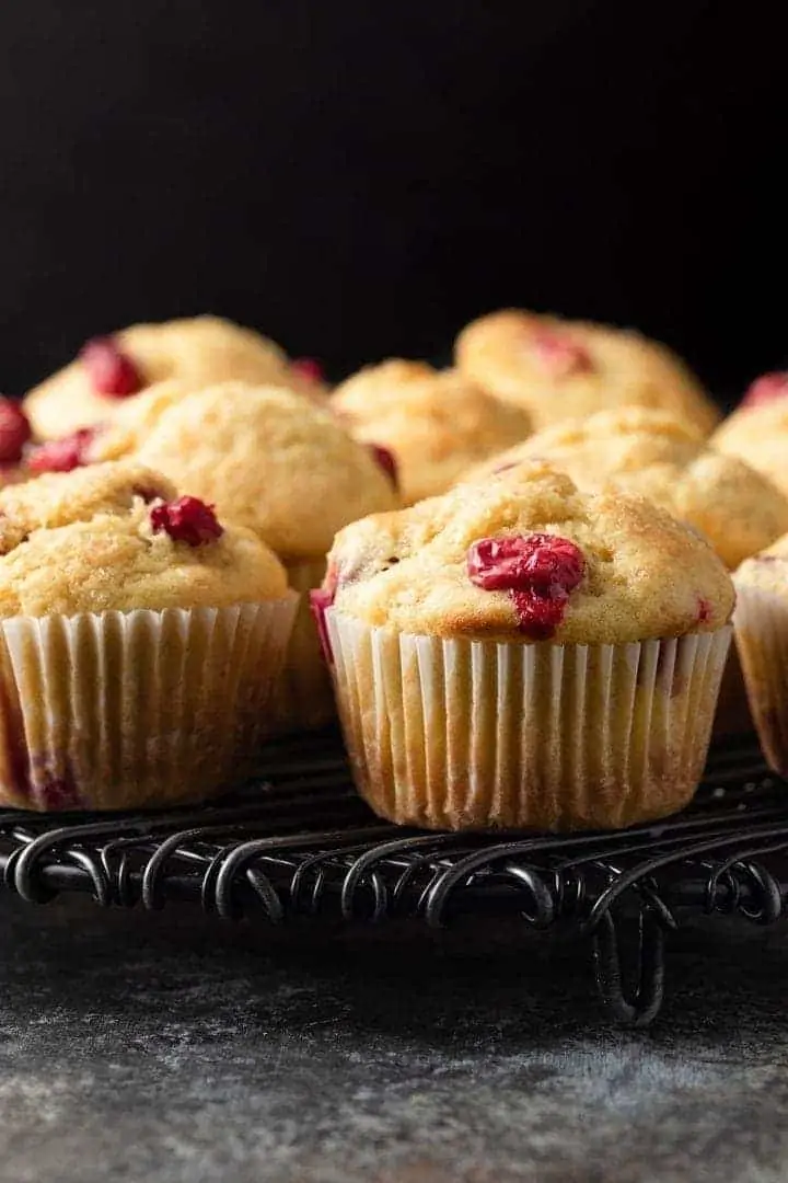 close up of cranberry orange muffins on a cooking rack