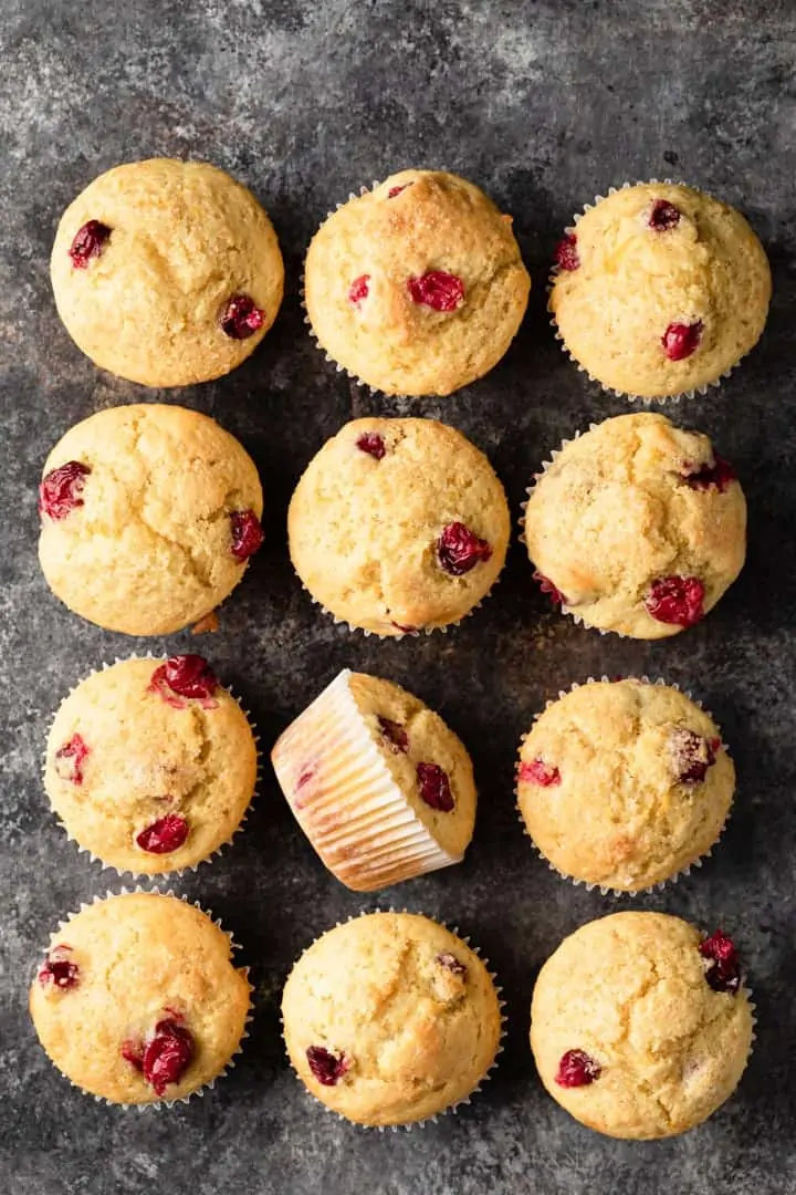 overhead of cranberry orange muffins arranged on a dark background