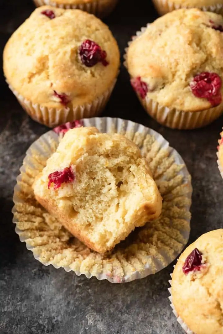 cranberry orange muffin with a bite taken out so the inside is visible