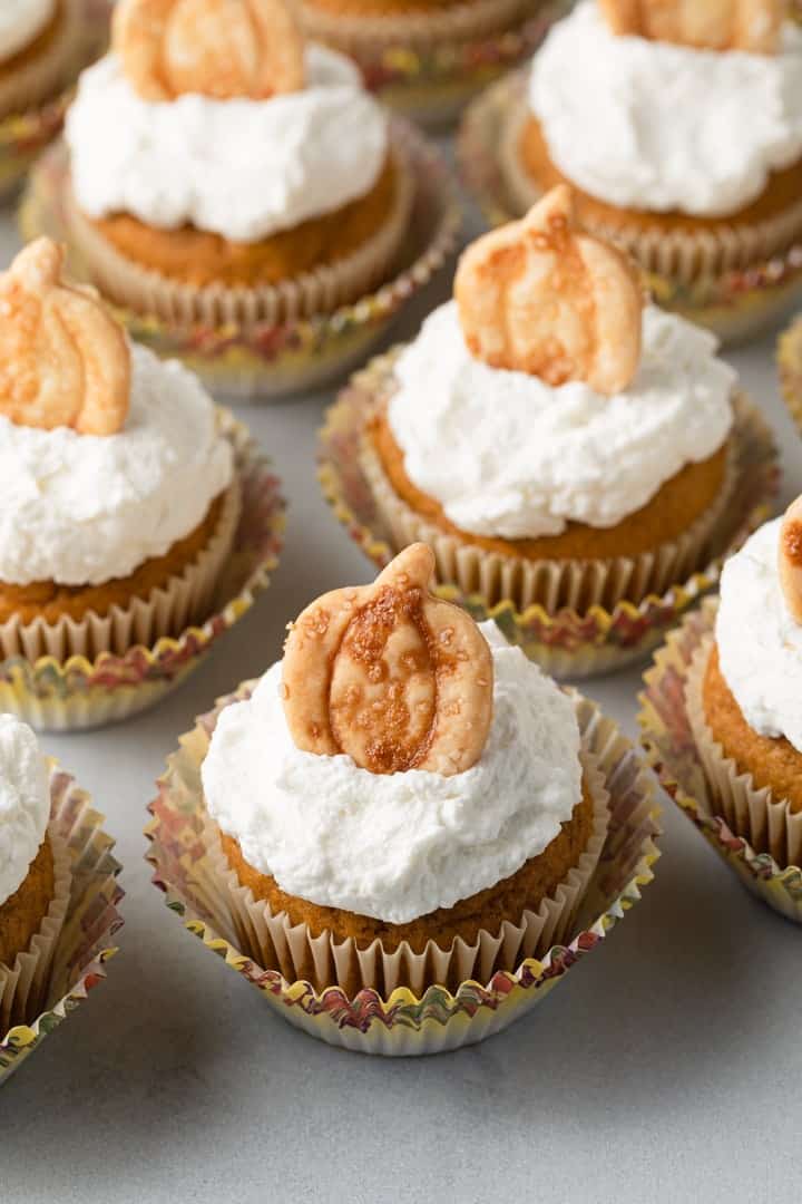 High angled view of pumpkin pie cupcakes on a white tabletop