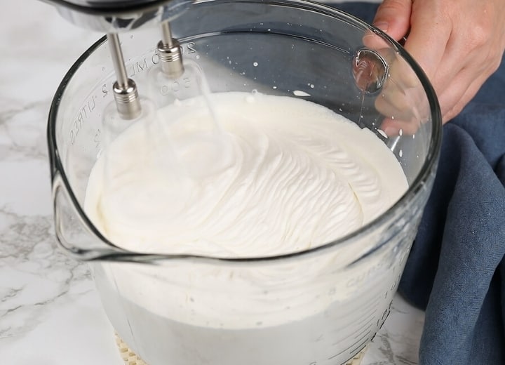 whipped cream frosting in a glass bowl