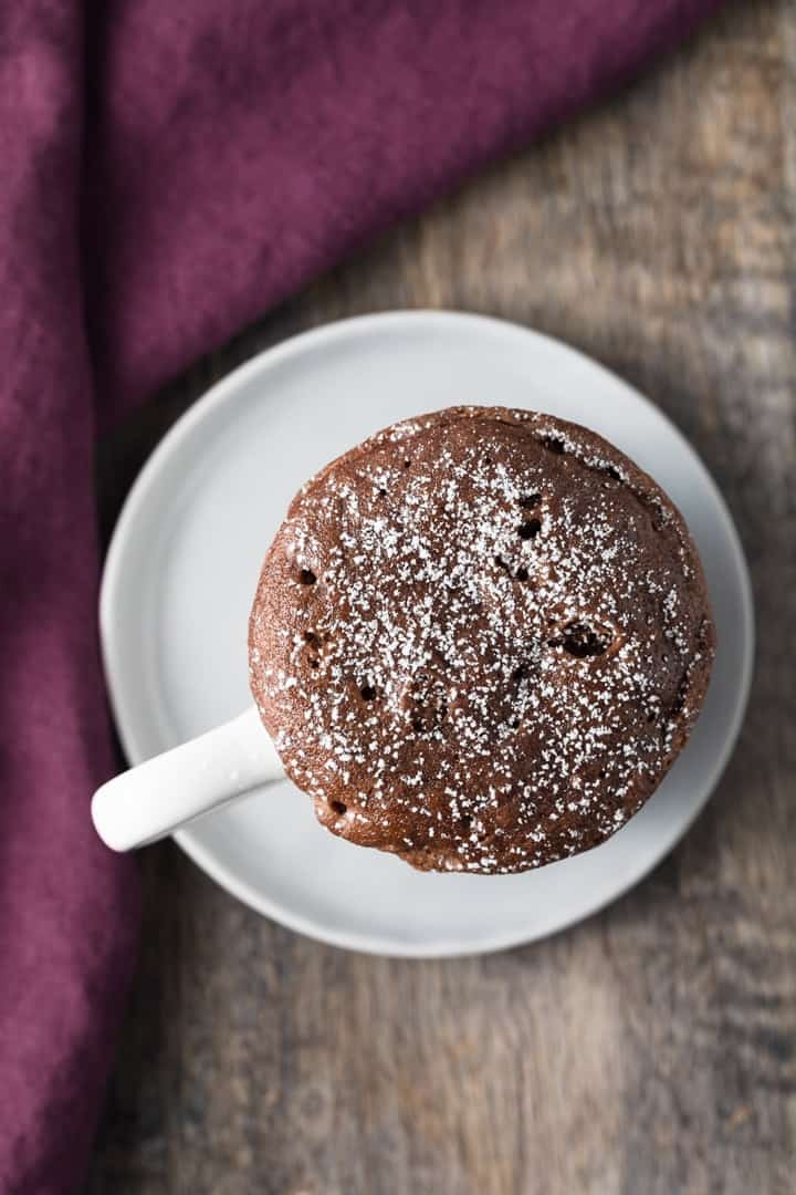 overhead view of Nutella mug cake in a white cup